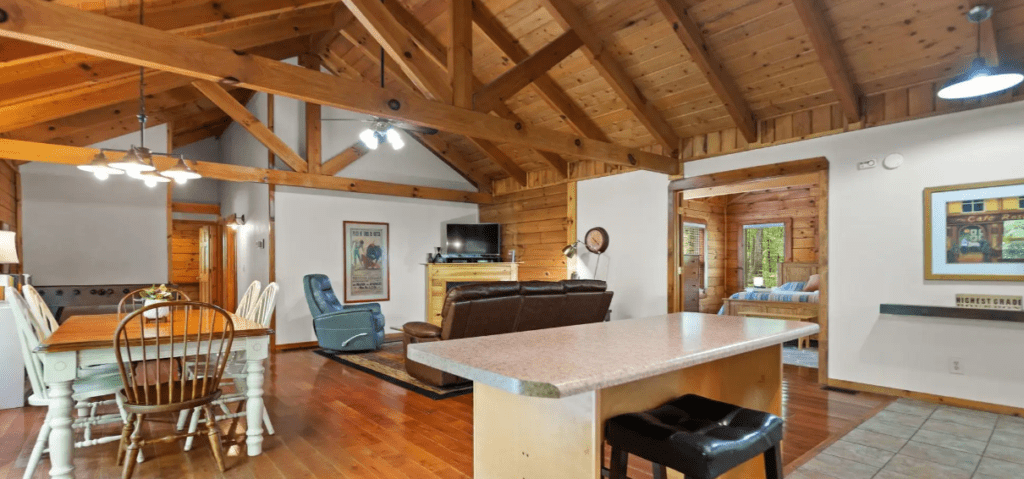 City Slicker Getaway- Inside | Scenic Cabin Rentals the Kitchen and Living Room Area is Perfect for Family Meals and Fun Games.